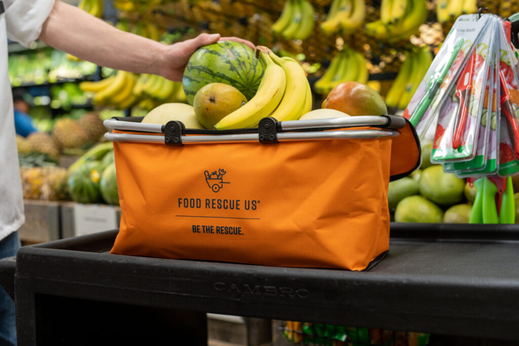 Placing fresh fruit into a Food Rescue US bag