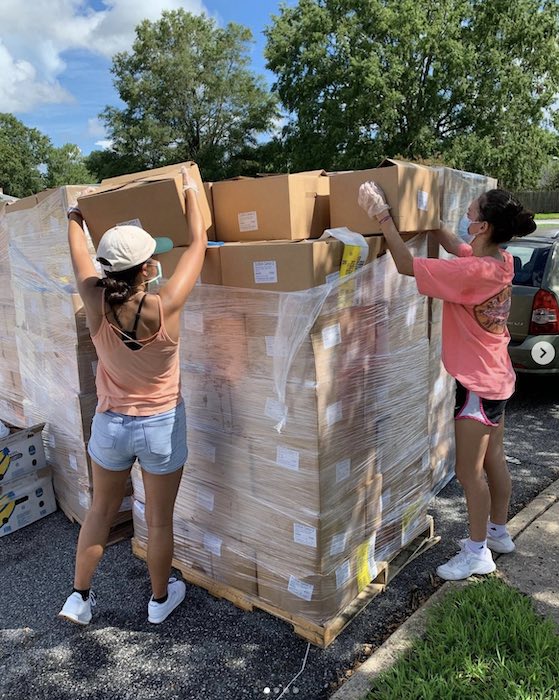 Two teens unload a pallet of USDA Food boxes