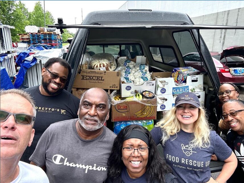 Group of Food Rescue US volunteers in front of a truck full of food in Detroit