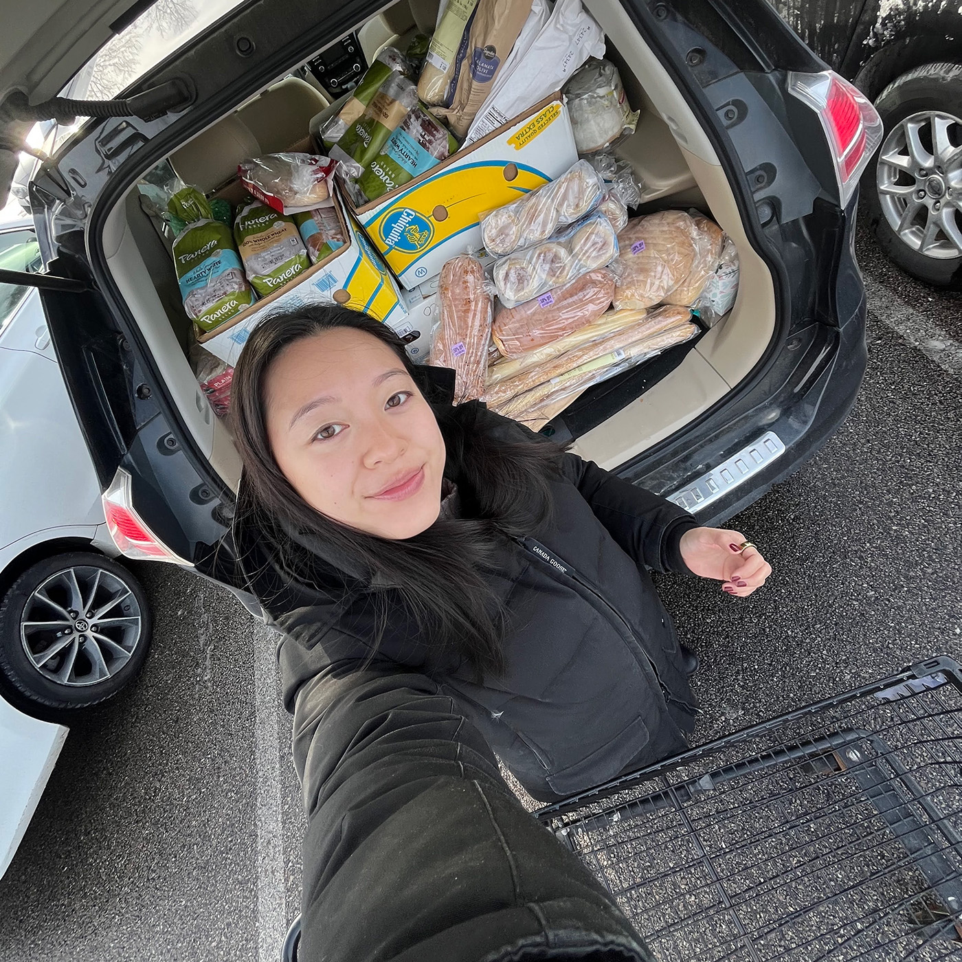 Boston volunteer selfie in front of full trunk