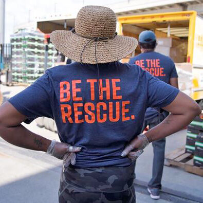 Food Rescue US volunteer with BE THE RESCUE on the back of her shirt