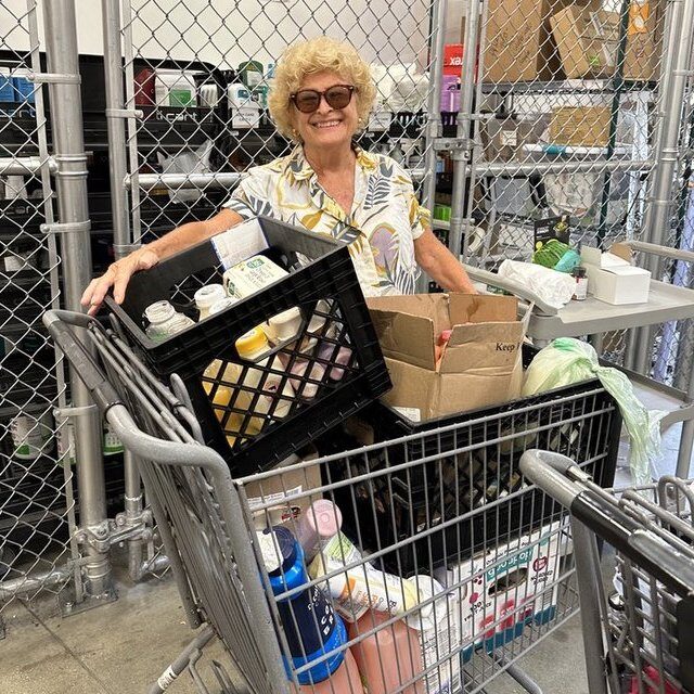 Volunteer rescuing cart full of food in Nassau County